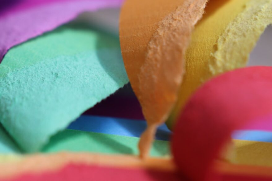 Close up of colorful pieces of paper.