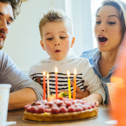 Kleiner Junge feiert Geburtstag mit Mama und Papa