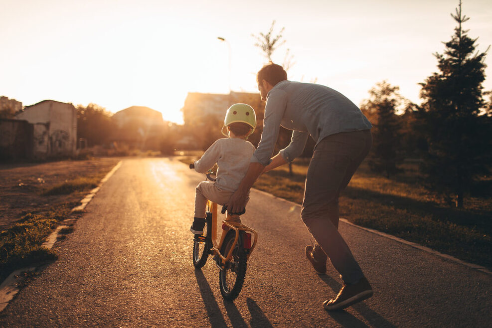 Vater bringt seinem Sohn das Radfahren bei.