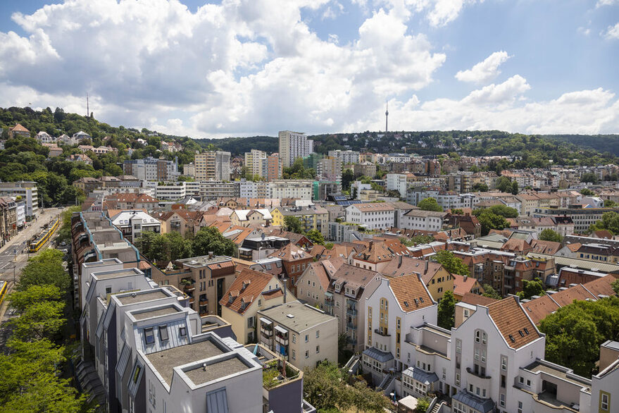 Blick auf mehrere Häuser, im Hintergrund Wald und der Fernsehturm.