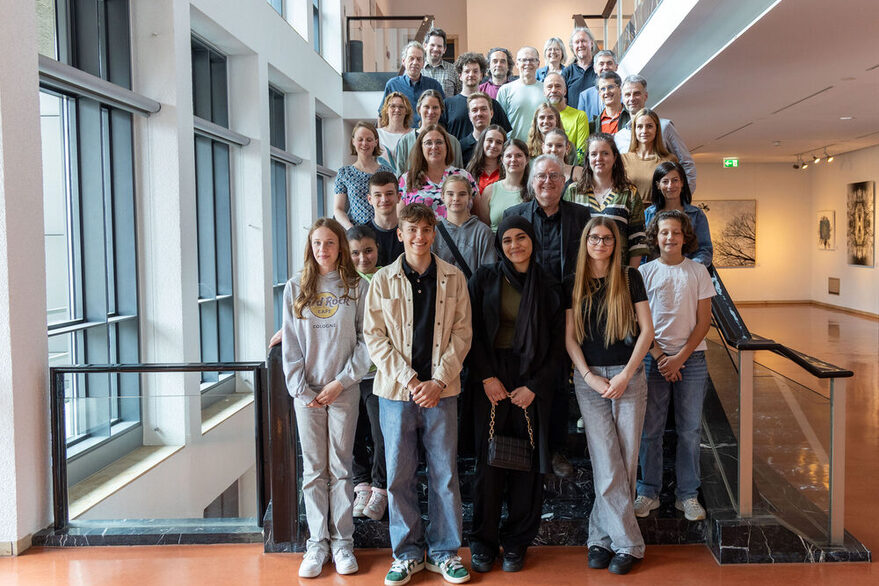 Rund 30 Teilnehmer, Schülerinnen und Schüler, Lehrerinnen und Lehrer und vertreter der Stadtverwaltung (unter anderem Bürgermeister für  Städtebau, Wohnen und Umwelt, Peter Pätzold, Dr. Jürgen Görres als Leiter der Abteilung Energie und Sandra Lange) stehen auf einer Treppe im Stuttgarter Rathaus für das Gruppenbild.