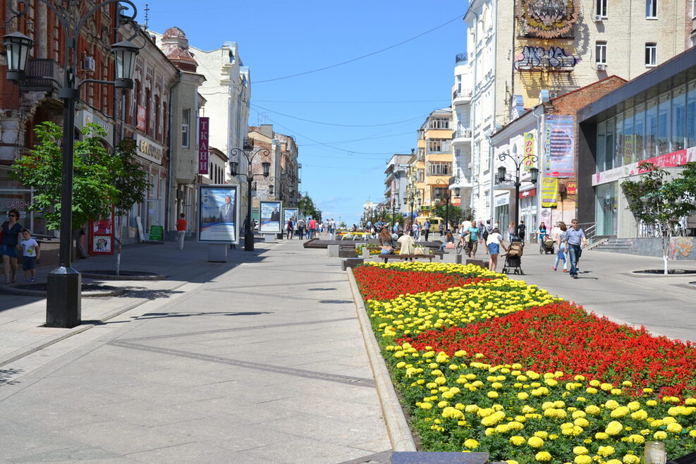 Eine Straße in der Innenstadt mit einem bunten Blumenbeet