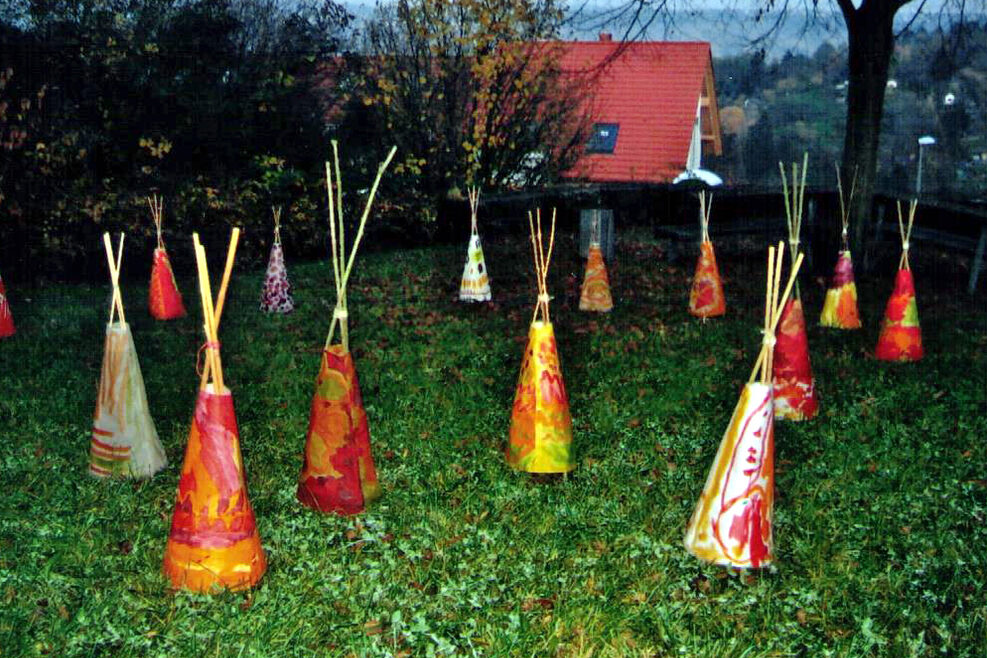 Im Garten stehen selbstgestaltete Tipi-Laternen.