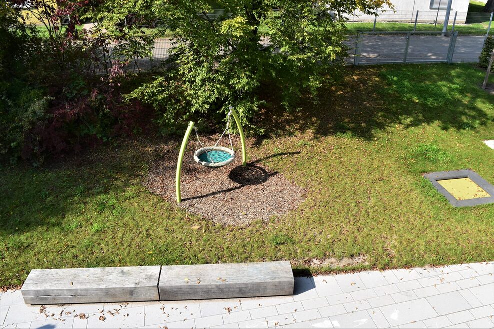 Der Gartenbereich für die Kleinen mit einer Korbschaukel.