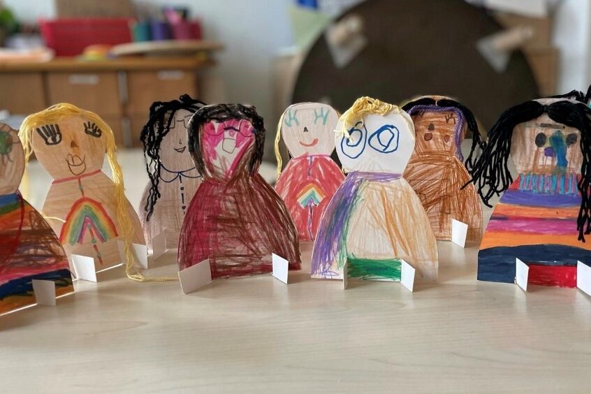Hand-sized paper figures made by children themselves.