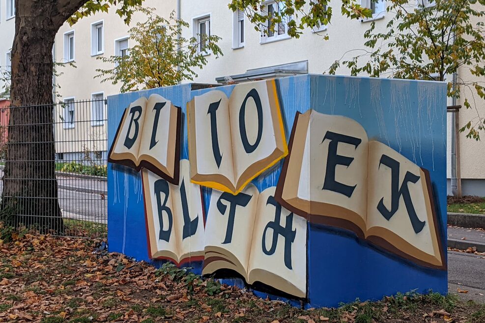 Graffiti Workshop Jugendrat: Betonbox für Mülltonnen mit Motiv in blauer Farbe