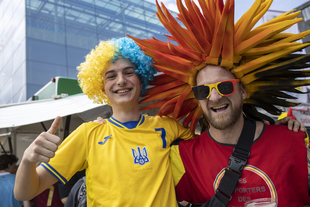 Ein ukainischer und ein belgischer Fan feiern zusammen.