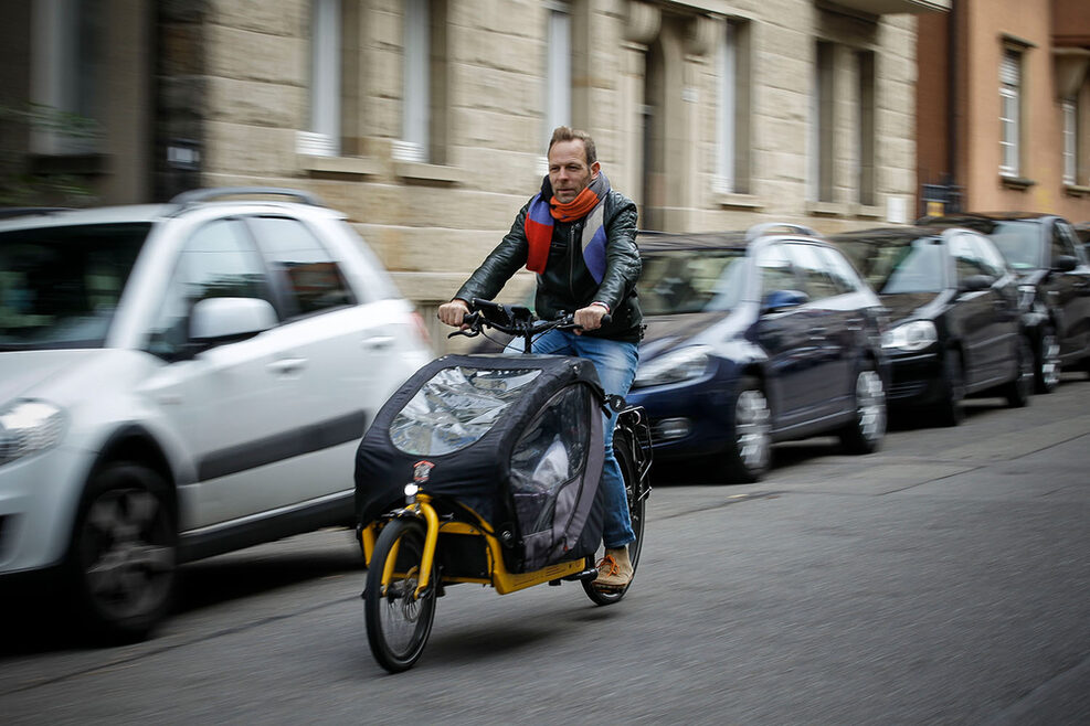 Ein Mann fährt auf einem Lastenfahrrad im Stuttgarter Süden.