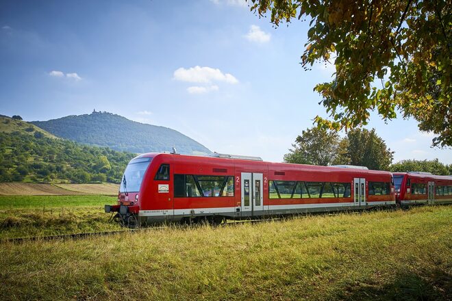 Rote S-Bahn fährt durch eine schöne Landschaft.