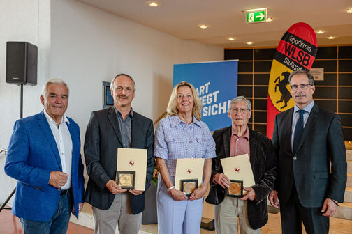 Group photo of the honorees with certificate and badge