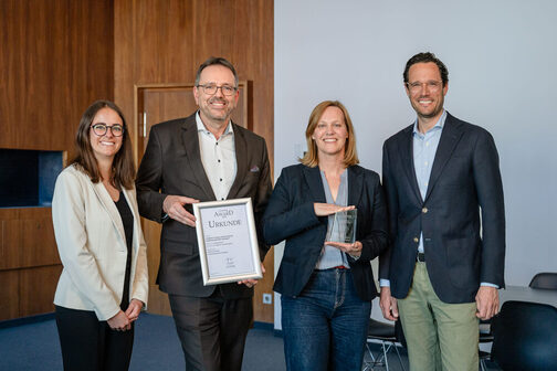 Gruppenbild: Erster Bürgermeister Dr. Fabian Mayer und weitere städtische Mitarbeitende präsentieren die Urkunde und den Award