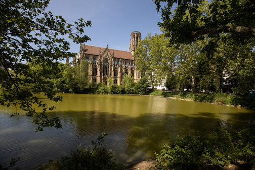 In the foreground is the Feuersee, surrounded by treetops, with St. John's Church in the background.