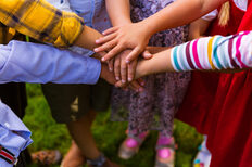 Kids joining hands together