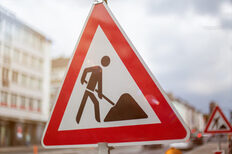 Construction site sign with pictogram of a construction worker.