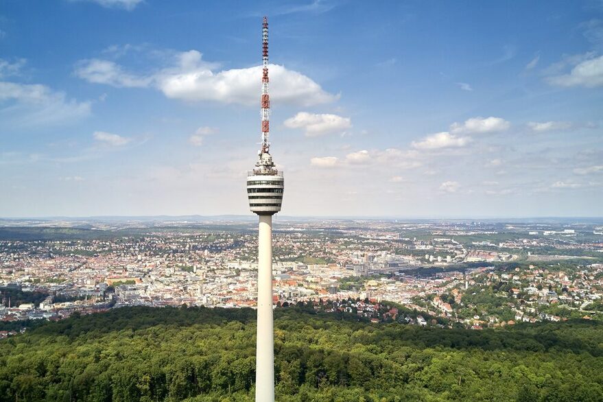 Blick auf den Stuttgarter Fernsehturm. Im Hintergrund ist Stuttgart und blauer Himmel zu sehen.