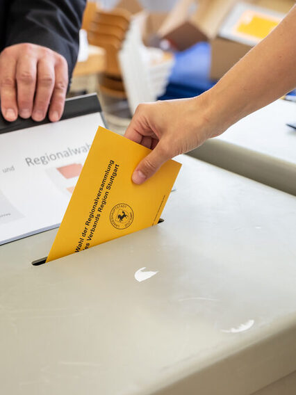 Stimmabgabe: Ein Umschlag wird in die Wahlurne eingeworfen.