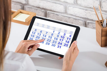 Businessperson Holding Digital Tablet With Calendar On Screen